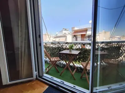 a balcony with a table and a table at Thissio Central - Pedestrian path in Athens