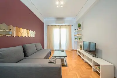 a living room with a couch and a television at Thissio Central - Pedestrian path in Athens
