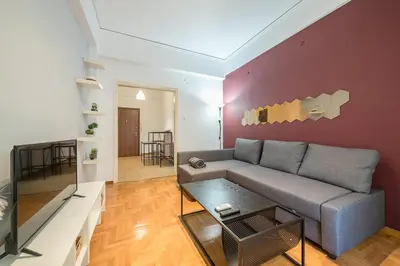 a living room with a couch and a table at Thissio Central - Pedestrian path in Athens