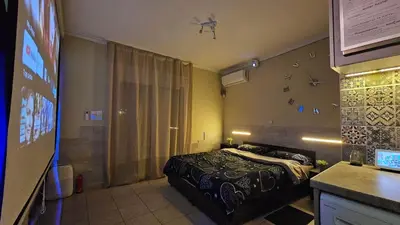 a hotel room with a bed and a bathroom at Έξυπνο όμορφο στούντιο διαμέρισμα στην Αθήνα με αυλή in Athens