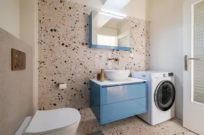 a bathroom with a sink and a washing machine at Athens Panorama Penthouse by Acropolis in Athens
