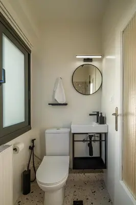 a bathroom with a white toilet and a mirror at Athens Panorama Penthouse by Acropolis in Athens
