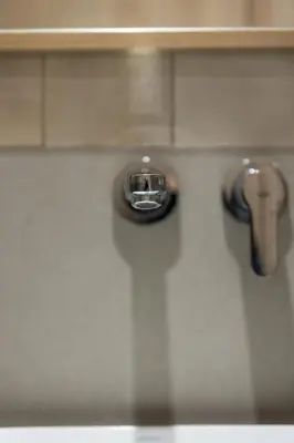 a close up of a toilet with a faucet at Vouliagmeni Square Resort in Athens