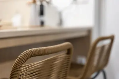 a rattan chair sitting in front of a counter at Vouliagmeni Square Resort in Athens
