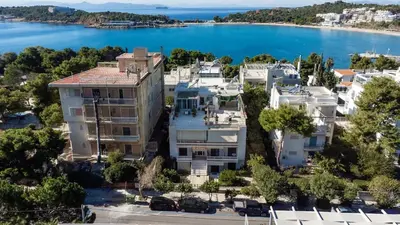 an aerial view of a building with the water in the background at Vouliagmeni Square Resort in Athens