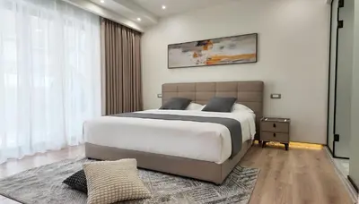 a bedroom with a large bed and a large window at CC LUX Suites in Piraeus Port in Piraeus