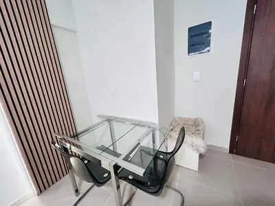 a glass table and chairs in a room at J seaside cozy APT in Athens