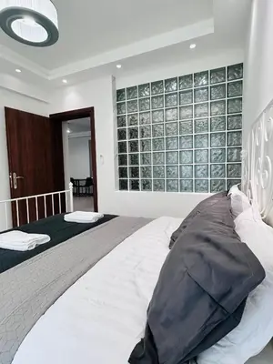 a bedroom with two beds and a large window at J seaside cozy APT in Athens