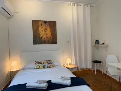 a bedroom with a bed with two towels on it at Near Acropolis Sunny Apartment! in Athens