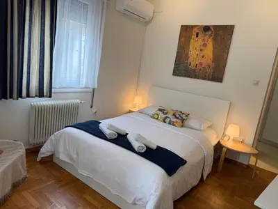 a bedroom with a bed with two pillows on it at Near Acropolis Sunny Apartment! in Athens