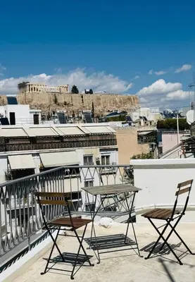 two chairs and a table on top of a balcony at Near Acropolis Sunny Apartment! in Athens