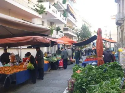 a group of people at an outdoor market with vegetables at Near Acropolis Sunny Apartment! in Athens