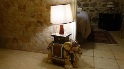 a lamp sitting on top of a rocking horse at STONE of KAMARIZA in Áyios Konstandínos