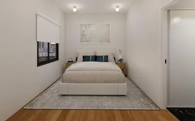 a white bedroom with a bed and a rug at The Acropolis Penthouse in Athens