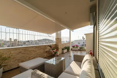 a balcony with a couch and a table at Gkizi View in Athens