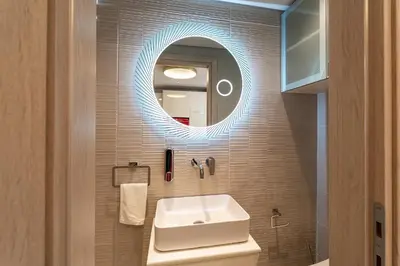 a bathroom with a sink and a mirror at Gkizi View in Athens
