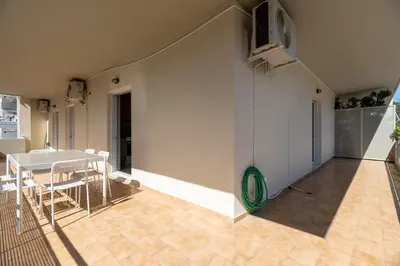 a living room with a table and a white wall at A2 3-Bedrms Ap 112sm 850m Metro Evangelismos 150m EKPA Univ Campus 100m Bus Stop to Acropolis in Athens