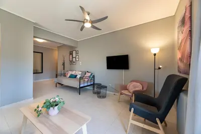 a living room with a couch and a tv at A2 3-Bedrms Ap 112sm 850m Metro Evangelismos 150m EKPA Univ Campus 100m Bus Stop to Acropolis in Athens