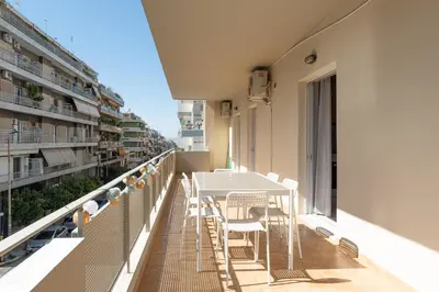 a balcony with a table and chairs on a building at A2 3-Bedrms Ap 112sm 850m Metro Evangelismos 150m EKPA Univ Campus 100m Bus Stop to Acropolis in Athens