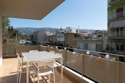 a balcony with a white table and chairs on it at A2 3-Bedrms Ap 112sm 850m Metro Evangelismos 150m EKPA Univ Campus 100m Bus Stop to Acropolis in Athens