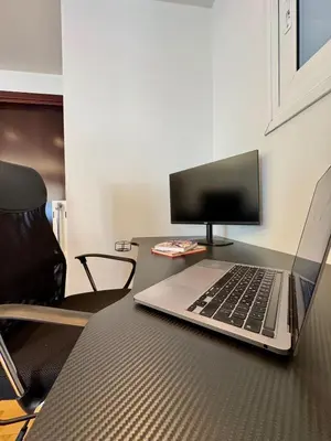 a laptop computer sitting on top of a table at Bright Apartment Syntagma Square in Athens