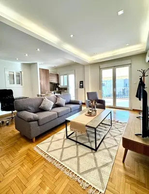 a living room with a couch and a table at Bright Apartment Syntagma Square in Athens
