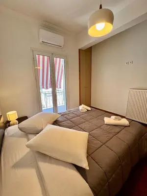 a bedroom with a large bed with two pillows on it at Bright Apartment Syntagma Square in Athens