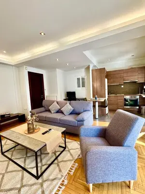 a living room with two couches and a table at Bright Apartment Syntagma Square in Athens