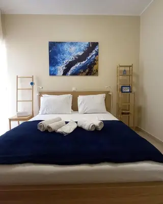a bedroom with a large bed with towels on it at C4 2-Rooms apt 3rd 850m Metro Evangelismos 150m EKPA Univ Campus 100m Bus Stop to Acropolis in Athens