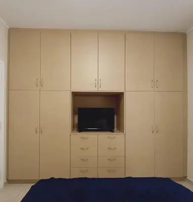 a bedroom with white cabinets and a tv at C4 2-Rooms apt 3rd 850m Metro Evangelismos 150m EKPA Univ Campus 100m Bus Stop to Acropolis in Athens