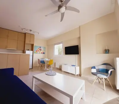 a living room with a white table and a ceiling fan at C4 2-Rooms apt 3rd 850m Metro Evangelismos 150m EKPA Univ Campus 100m Bus Stop to Acropolis in Athens