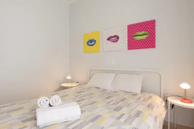 a bedroom with a bed with towels on it at C5 3rd floor balcony view 1bdr flat 850m Metro Evangelismos 150m EKPA University Campus 100m Bus Stop to Acropolis in Athens