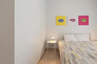 a bedroom with a bed and a side table at C5 3rd floor balcony view 1bdr flat 850m Metro Evangelismos 150m EKPA University Campus 100m Bus Stop to Acropolis in Athens