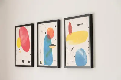 a group of four framed paintings on a wall at C5 3rd floor balcony view 1bdr flat 850m Metro Evangelismos 150m EKPA University Campus 100m Bus Stop to Acropolis in Athens