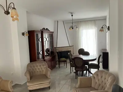 a living room with a table and chairs at Giorgio in Piraeus