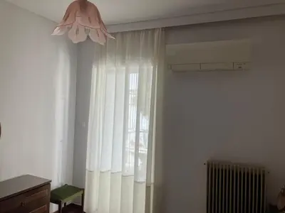 a room with a window with curtains and a fan at Giorgio in Piraeus