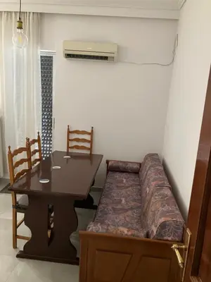 a room with a couch and a table and a table and chair at Giorgio in Piraeus