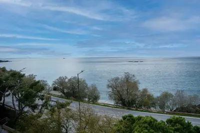 a view of the ocean and a road next to it at Athenian Riviera Seafront Residence in Saronida