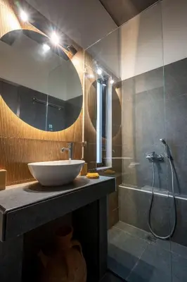 a bathroom with a sink and a shower at Athenian Riviera Seafront Residence in Saronida