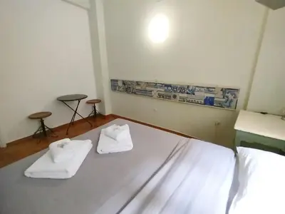 a room with a bed with two towels on it at Spacious Apartment near Parthenon in Athens