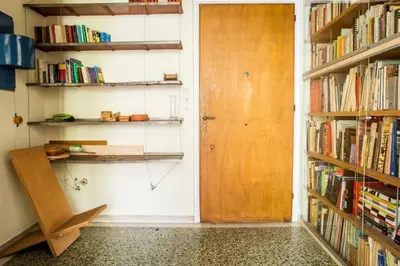 a room with a door and shelves of books at Spacious Apartment near Parthenon in Athens