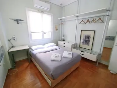 a bedroom with a large bed with two towels on it at Spacious Apartment near Parthenon in Athens