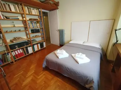 a bedroom with a bed with two towels on it at Spacious Apartment near Parthenon in Athens