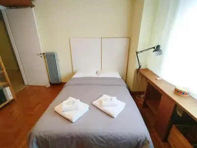 a bedroom with two beds with towels on them at Spacious Apartment near Parthenon in Athens