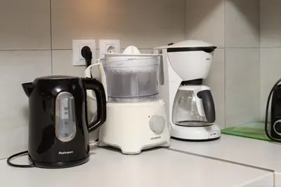 a kitchen counter with a blender and a coffee maker at Spacious Apartment Downtown Glyfada in Athens