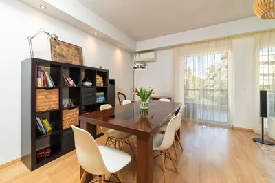a dining room with a table and chairs at Spacious Apartment Downtown Glyfada in Athens