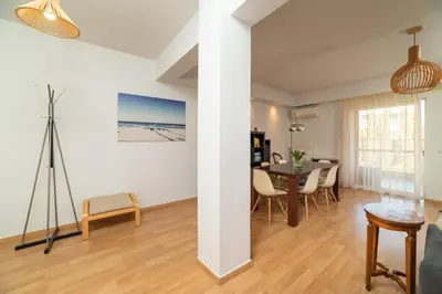 a dining room and living room with a table and chairs at Spacious Apartment Downtown Glyfada in Athens
