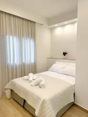 a bedroom with a bed with towels on it at Urban Pad Athens in Athens