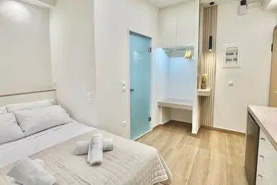 a bedroom with a bed with towels on it at Urban Pad Athens in Athens