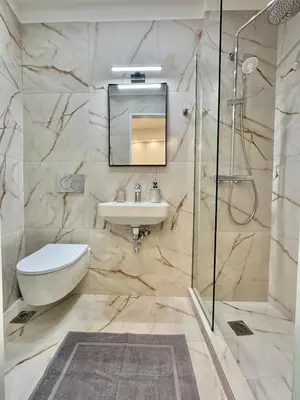 a bathroom with a sink toilet and a shower at Urban Pad Athens in Athens